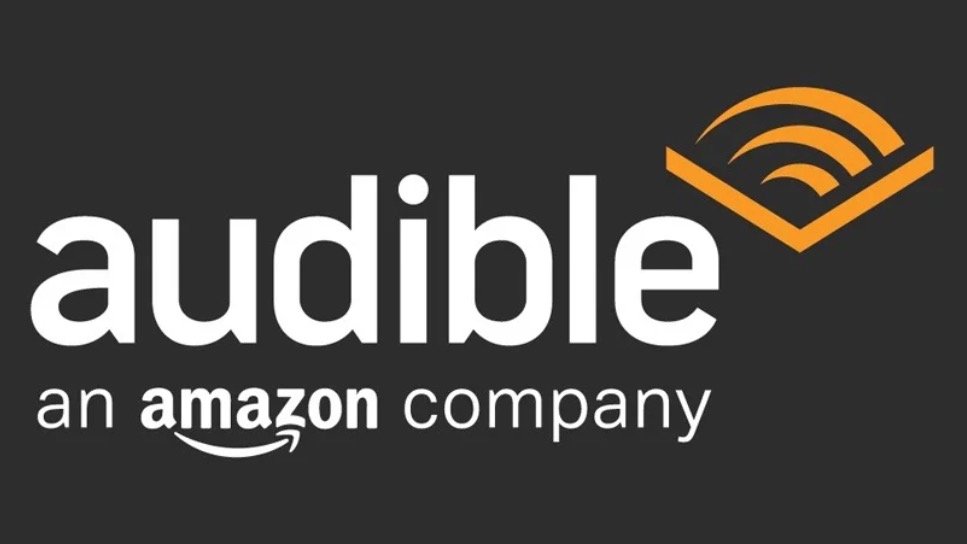 Audible logo, an Amazon company, with orange sound wave icon on dark background.